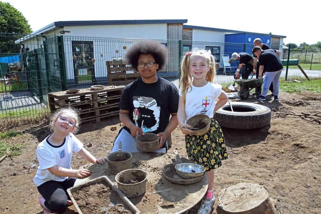 Team leader Malachi Brown from Harrison College with Saltersgate Infant school pupils, Isobelle Taylor,6 and Thea Ormshaw, 6 in the mud kitchen area