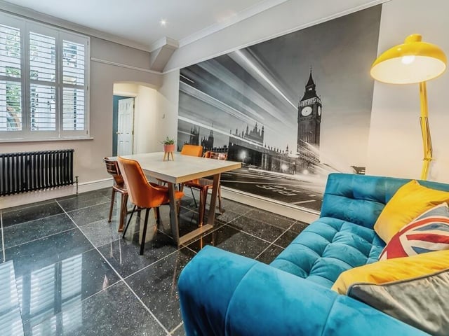 A sizeable dining room is made cosy by a woodburner stove.