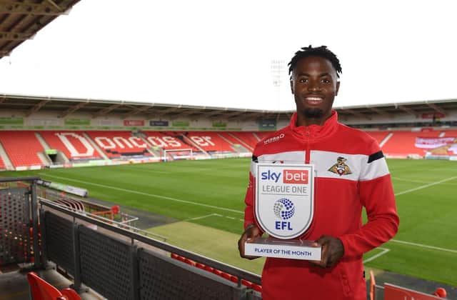 Madger Gomes with his League One player of the month award. Picture: Howard Roe/AHPIX