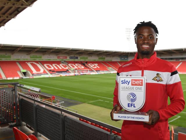 Madger Gomes with his League One player of the month award. Picture: Howard Roe/AHPIX