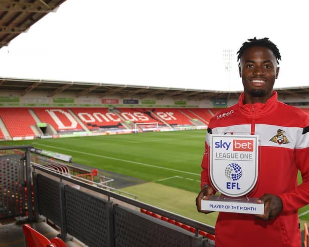 Madger Gomes with his League One player of the month award. Picture: Howard Roe/AHPIX