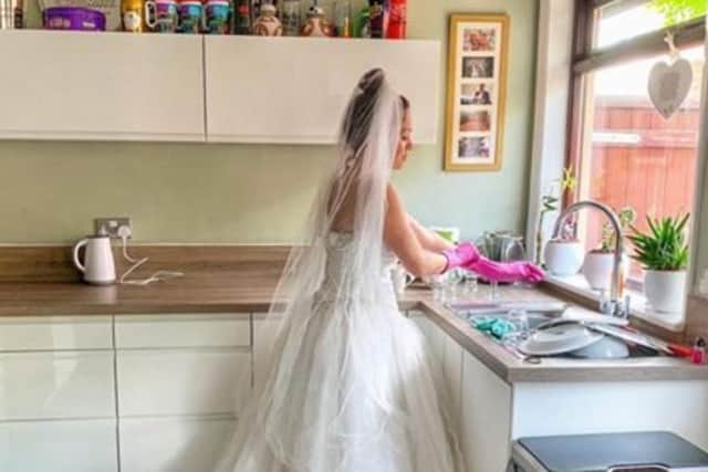 Mindy Waterhouse gets on with the chores in her wedding dress