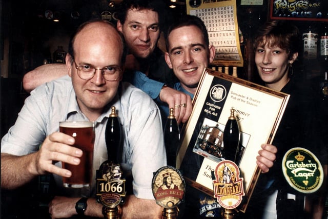 Licensee Sean Lithgo (third left) with the summer Pub of the Season award certificate presented to him by Peter Marsh (left) of Doncaster's CAMRA branch.  Also behind the bar of The Queen, a festival ale house in Sunny Bar, are pub staff Ben Walshaw and Kelly Jackson, September 1997