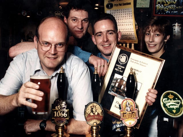 Licensee Sean Lithgo (third left) with the summer Pub of the Season award certificate presented to him by Peter Marsh (left) of Doncaster's CAMRA branch.  Also behind the bar of The Queen, a festival ale house in Sunny Bar, are pub staff Ben Walshaw and Kelly Jackson, September 1997