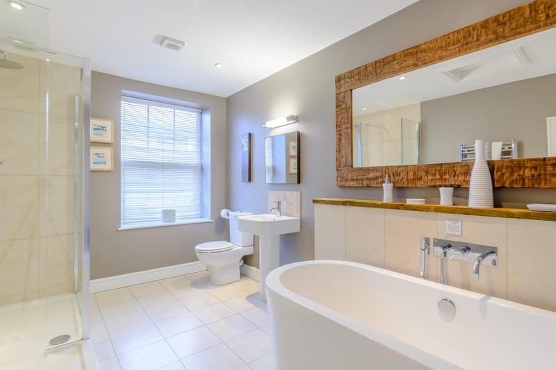 An en suite bathroom with freestanding bath and separate walk-in shower.