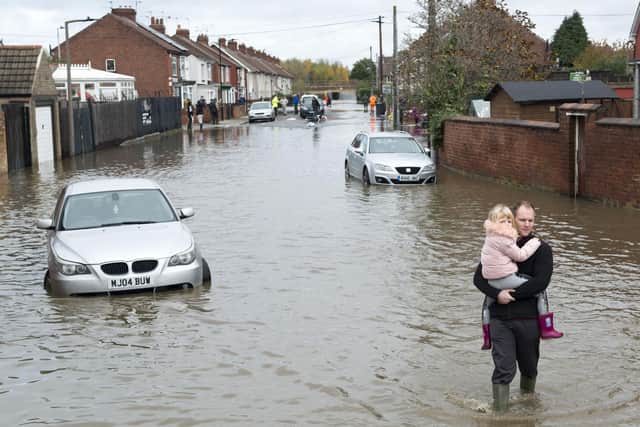 A father takes his daughter to safety as Yarborough Terrace in Doncaster floods as the River Don bursts its banks after heavy rain. The floods were one of the biggests emergencies during Shaun Morley's time as a police chief