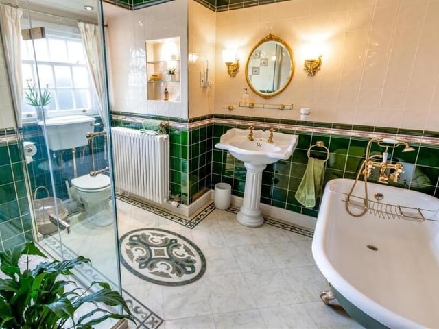 The main bathroom with freestanding bath and walk-in shower unit.
