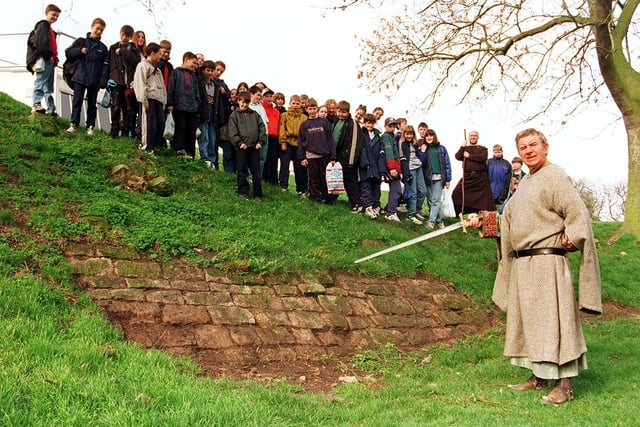 Conisbrough Castle's Dave Haywood points out the uncovered stones, watched by visiting school children and volunteer guide Mick Martin in March 1997