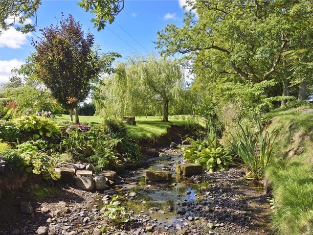A stream runs through the gardens at Langbank - with a bridge to get across
