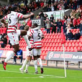 Doncaster's players celebrate one of their four goals.