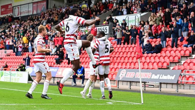Doncaster's players celebrate one of their four goals.