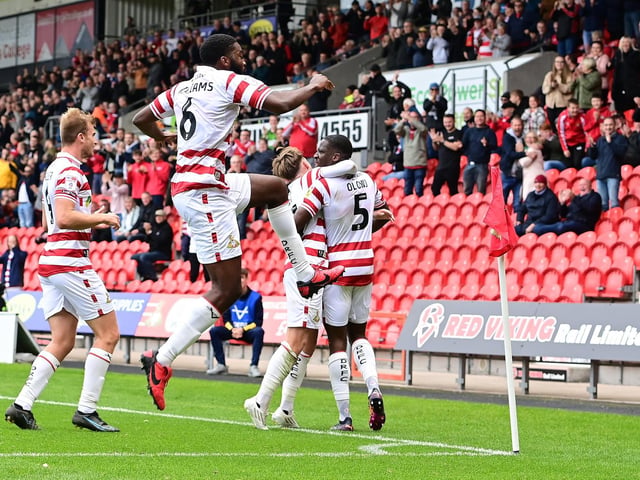 Doncaster's players celebrate one of their four goals.