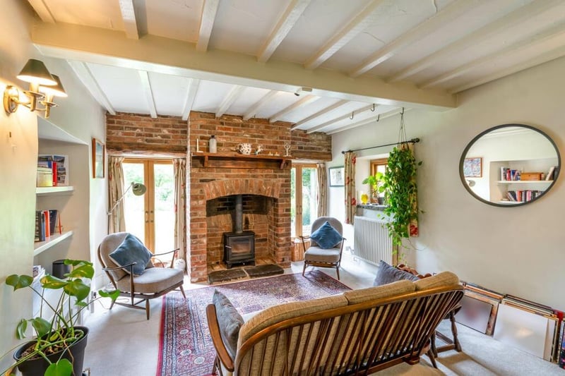 A room for all seasons - with a cosy wood burning stove for cooler months, and doors out to the gardens for the summer.