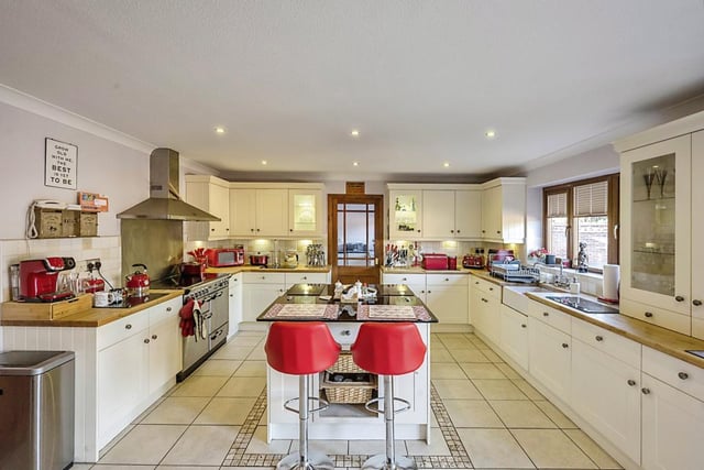 A stunning large kitchen with central island.
