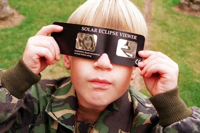 Young Ben Martin views the solar eclipse with the help of a solar eclipse viewer at Conisbrough Castle, August 11, 1999
