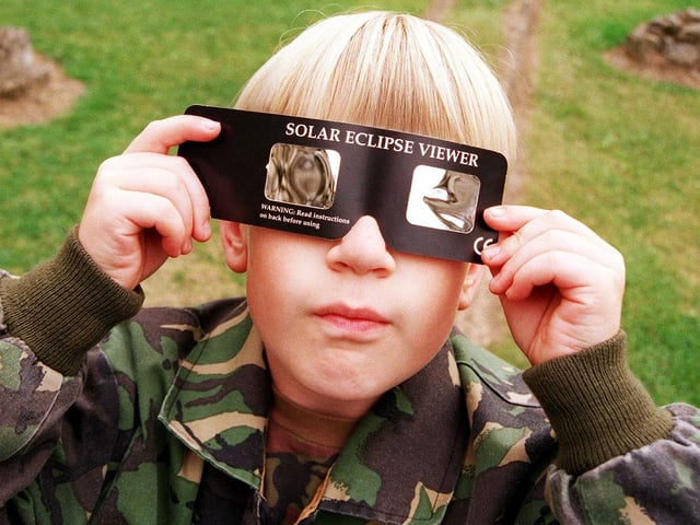 Young Ben Martin views the solar eclipse with the help of a solar eclipse viewer at Conisbrough Castle, August 11, 1999