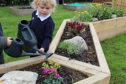The new outdoor area includes flower beds for children to try their hand at gardening.