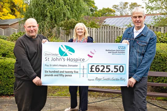Roger, left, is pictured handing over his cheque to Lindsey, with DJ Gary Wilton