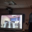Medical student India Mayhook-Walker using Meta’s Oculus Quest 2 virtual reality headset as well as Oxford Medical Simulation software.