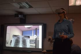 Medical student India Mayhook-Walker using Meta’s Oculus Quest 2 virtual reality headset as well as Oxford Medical Simulation software.