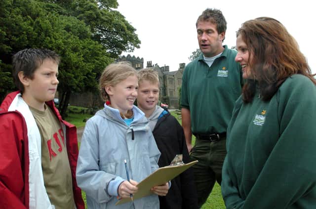 Pupils from Grindleford Primary School, l/r: Jack Brown, 10,  Rebecca Bowman,11,  and Charlie Bushell, 10, interview  National Trust staff Mark Bull and Helen Willett at the Longshaw Estate in 2004