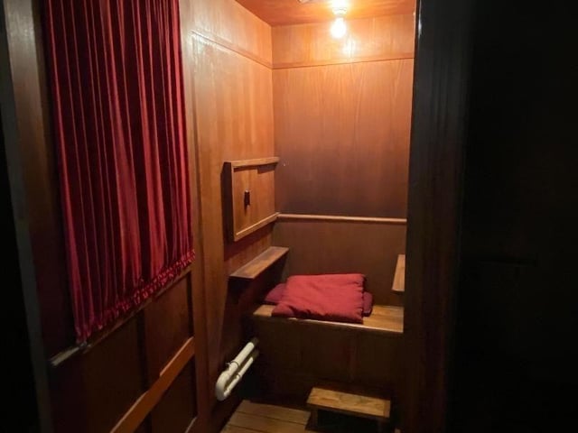 The baptism font is outside the chapel doors next to the confessionals