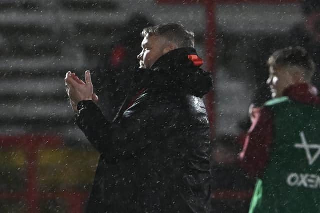 Doncasters Rovers' manager Grant McCann applauds the travelling fans in the driving rain after the 0-0 draw at Accrington Stanley. Picture: Howard Roe/AHPIX LTD