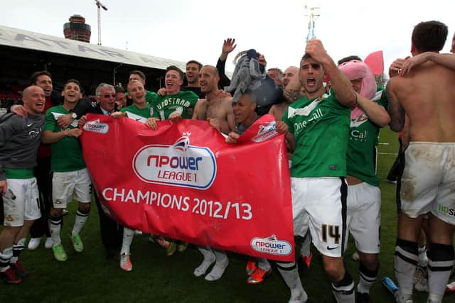 Doncaster Rovers players celebrate winning League One at Griffin Park