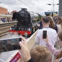 Guests look on as Flying Scotsman leaves Doncaster Railway Station, celebrating her centenary by making a return to the city where she was built one hundred years ago. Photo credit: Dominic Lipinski/PA Wire