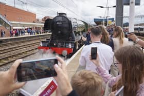 Guests look on as Flying Scotsman leaves Doncaster Railway Station, celebrating her centenary by making a return to the city where she was built one hundred years ago. Photo credit: Dominic Lipinski/PA Wire