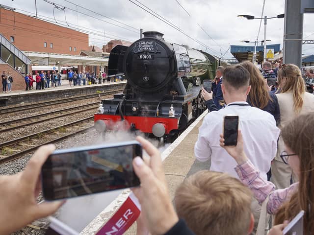 Guests look on as Flying Scotsman leaves Doncaster Railway Station, celebrating her centenary by making a return to the city where she was built one hundred years ago. Photo credit: Dominic Lipinski/PA Wire