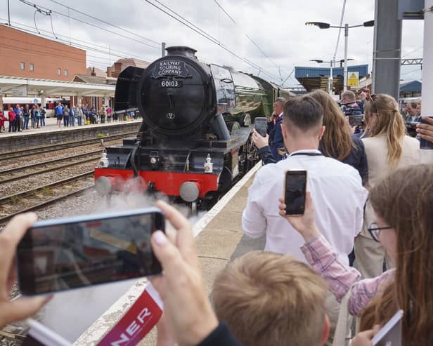 Guests look on as Flying Scotsman leaves Doncaster Railway Station, celebrating her centenary by making a return to the city where she was built one hundred years ago. Photo credit: Dominic Lipinski/PA Wire