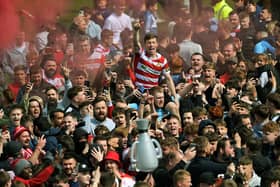 Doncaster Rovers' Harry Clifton in the thick of the promotion celebrations against Bradford City last month. Picture: Jonathan Gawthorpe