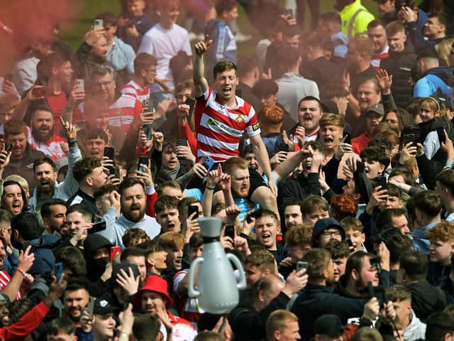Doncaster Rovers' Harry Clifton in the thick of the promotion celebrations against Bradford City last month. Picture: Jonathan Gawthorpe