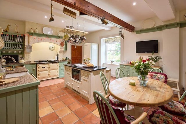 The farmhouse dining kitchen has a programmable Aga, along with a pantry and a utility room.