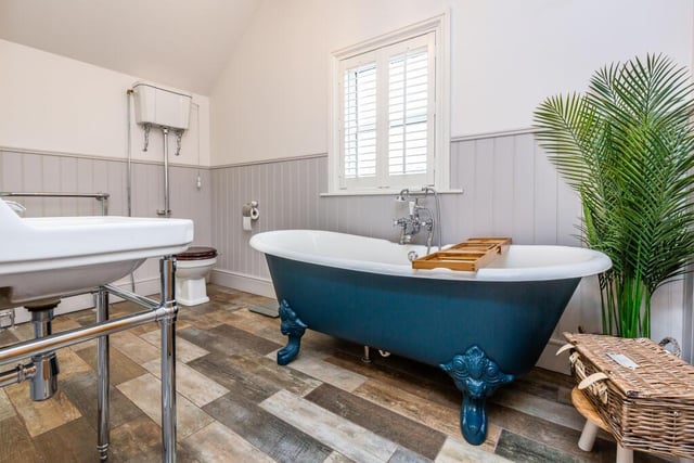 One bathroom features a free standing bath tub.
