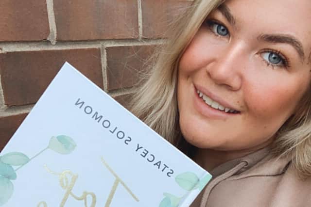 Charlotte Louise Sharpe with the book.