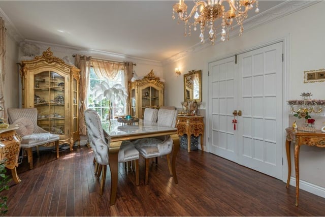 A bright living and dining room with large double doors.