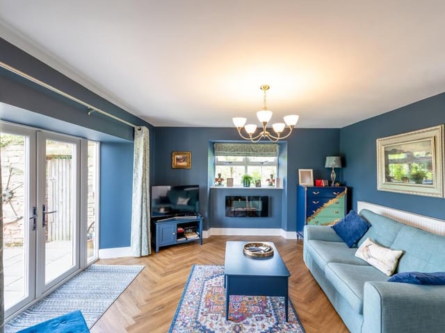 Inside the annexe: an attractive living room with double doors to outside, and exceptional views.