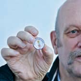 Cancer survivor Paul Gilligan with his badge