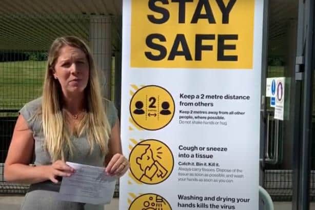 Hannah Smith, associate Vice Principal, with safety notices outside Outwood Academy Adwick