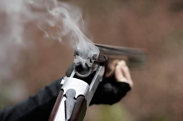 Closeup of a smoking traditional skeet shooting shotgun after shots fired