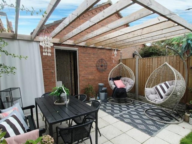 A garden seating area with pergola.