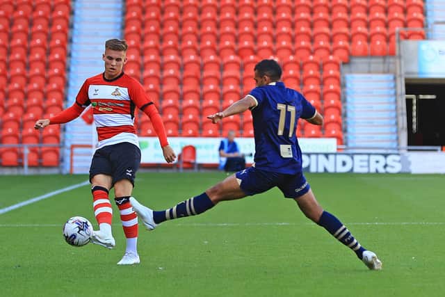 Doncaster Rovers' George Broadbent lifts the ball forward against Port Vale.