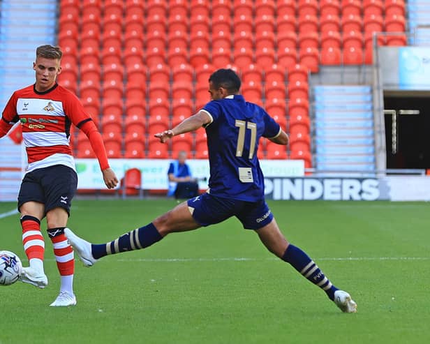 Doncaster Rovers' George Broadbent lifts the ball forward against Port Vale.