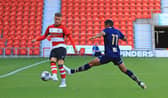 Doncaster Rovers' George Broadbent lifts the ball forward against Port Vale.