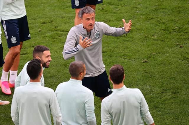 Spain head coach Luis Enrique interacts with his players during training. Photo by Wolfgang Rattay - Pool/Getty Images