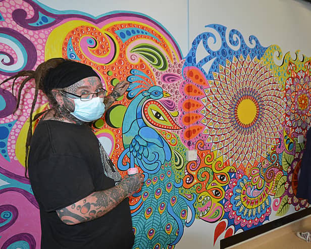 John and Morag alongside the mural