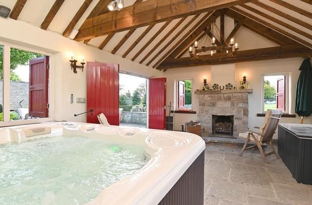 The hot tub room or party barn is attached to a barn and separate garage.