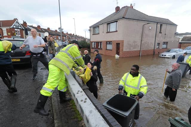 Workers hand sandbags out in Bentley following flooding back in 2019.